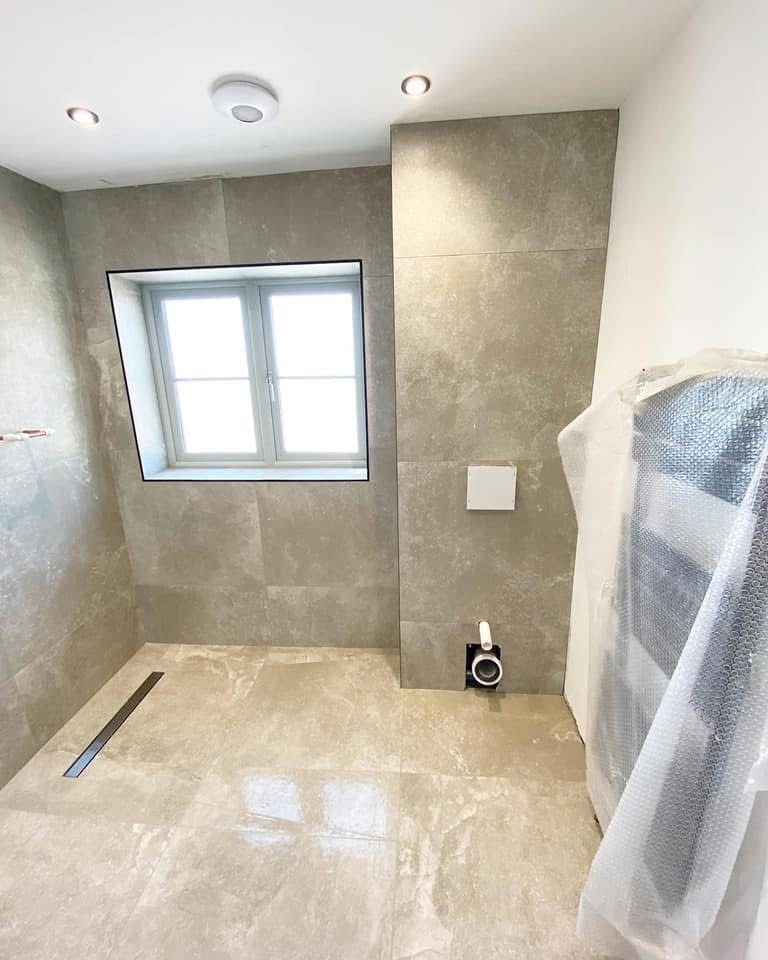 Fully tanked wetroom with stone-effect tiles and linear drain