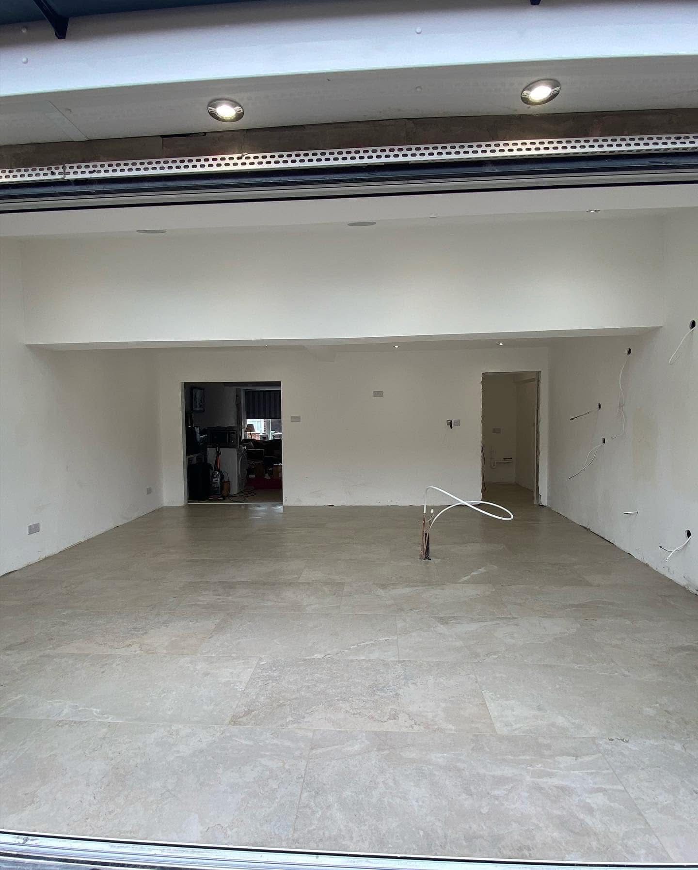 Large format stone-effect porcelain floor tiles in open-plan extension