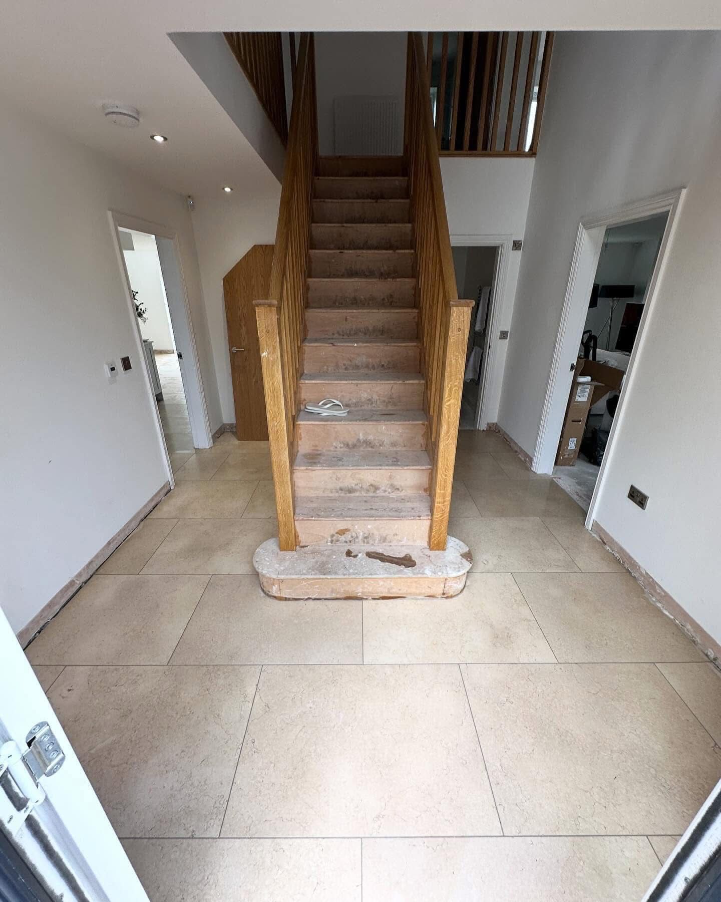 Hallway with stone-effect porcelain floor tiling